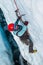 Female ice climber smashing ice tool into glacier ice in Alaska