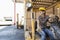 Female industrial worker looking away while driving forklift truck