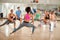 Female instructor show exercises to fitness group