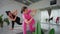 Female instructor teaches yoga poses to an elderly student