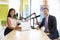 Female interviewer and guest in a studio smiling to camera