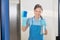 Female Janitor Cleaning Glass