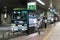 Female japanese passenger looking at the timetable in the Hiroshima bus center, Japan.