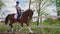 Female Jockey Riding On The Back Of her Dark bay Horse - The Horse Running