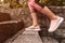 Female jogger warming up for training by running up the stairs in park