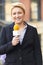 Female Journalist Broadcasting Outside Office Building