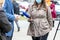 Female journalist wearing protective face mask against coronavirus COVID-19 disease holding microphone at media event making press