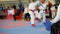 Female karatekas fight on karate competitions, blurred sport background