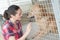 Female kennel employee checking dogs state