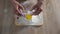 Female kid and grandmother hands adding egg to flour, family recipe, tradition