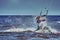 A female kiter slides on the surface of the water.