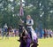 A Female Knight carries a flag on a horse at the Mid-South Renaissance Faire.