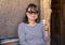 Female Korean tourist enjoying a tea in a home in a Berber village in the High Atlas Mountains of Morocco.