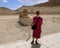 Female Korean tourist posing before a sphinx at the Mortuary Temple of Hatshepsut in Luxor, Egypt.