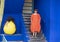 Female Korean tourist standing on steps next to a Purple Queen plant in the Jardin Majorelle in Marrakesh, Morocco.