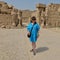 Female Korean tourist and statues in the Cachette Courtyard in front of the 7th Pylon