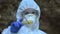 Female lab worker holding poison sign standing forest, dangerous level radiation