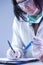 Female Laboratory Worker Dealing With Flask Containing Liquid Chemicals