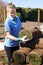 Female Landscape Gardener Laying Turf For New Lawn