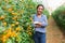 Female latino farmer cultivates yellow tomato growth