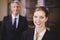 Female lawyer smiling while male colleague in background