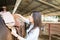 Female Learning Proper Position Of Saddle On Horse