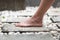 A female leg is standing on the stone floor of a large open-air bathroom. Interior Buddhist