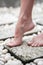 A female leg is standing on the stone floor of a large open-air bathroom. Interior Buddhist