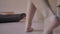 Female legs bare closeup walking on the floor