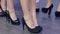 Female legs in black shoes, close-up of shoes on catwalk, collections shoes at fashion week