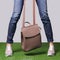 Female legs in comfort casual urban sneakers and leather bag
