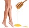 Female legs depilation by honey or sugar pasta.