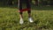 Female legs exercising with resistance band in park