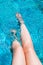 Female legs flounder in outdoor pool