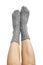 Female legs in grey hand knitted wool socks