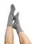 Female legs in grey hand knitted wool socks