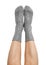 Female legs in grey hand knitted wool socks