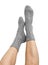 Female legs in grey hand knitted wool socks