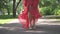 female legs in high heels closeup. a young girl in a dress waving in the wind. Slow motion