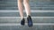 Female legs in high heels shoes walking on the stairs. Feet of businesswoman stepping up on stairway. Elegant woman