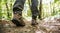 Female legs hiking on footpath in autumn forest.