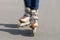 female legs on roller skates on asphalt in street, on track. legs of woman in skatepark in motion