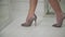 Female legs in a shoe with a weighty heel