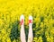 Female legs in sneakers sticking out of flowers. Legs up. Legs against the background of yellow blossoms