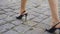 Female legs in stylish shoes walks down the street.