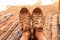 female legs in textile light sneakers on a multi-colored carpet in the desert in tents of boudoins close up