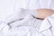 Female legs in white gray socks in white linens bed