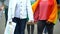 Female LGBT activists holding each other hand, rainbow symbols and posters