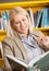 Female Librarian Holding Glasses While Reading