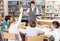 Female librarian and schoolkids during classes